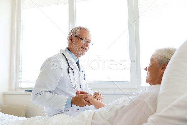 doctor checking senior woman pulse at hospital Stock photo © dolgachov