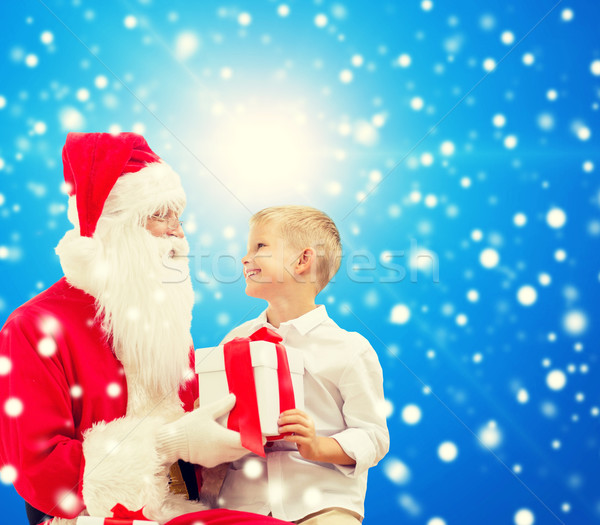 smiling little boy with santa claus and gifts Stock photo © dolgachov