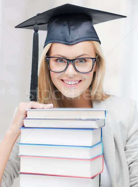 student in graduation cap Stock photo © dolgachov