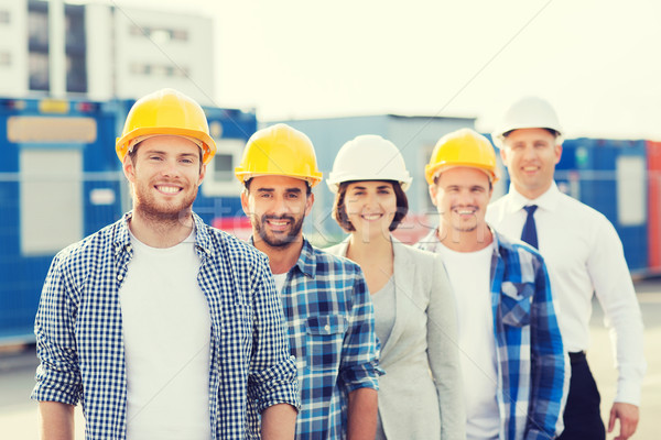 Grupo sorridente construtores ao ar livre negócio edifício Foto stock © dolgachov