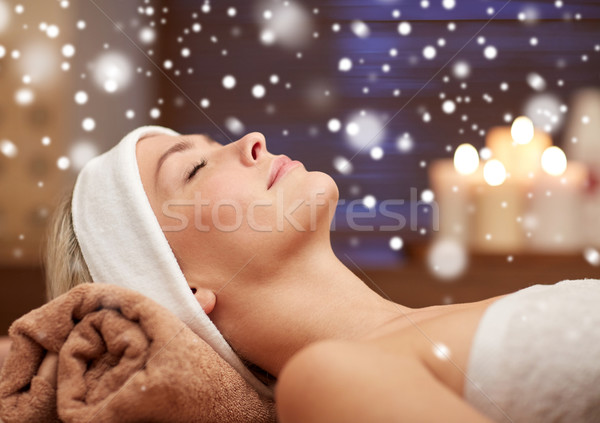 close up of smiling young woman lying in spa salon Stock photo © dolgachov