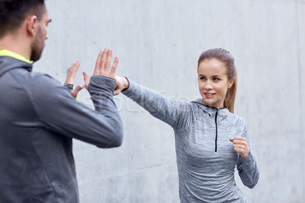 happy woman with coach working out strike outdoors Stock photo © dolgachov