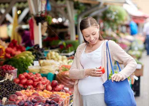 pregnant woman buying food at street market Stock photo © dolgachov