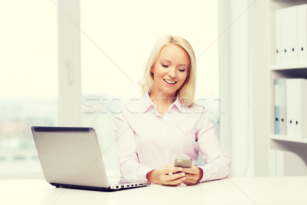 smiling businesswoman or student with smartphone Stock photo © dolgachov
