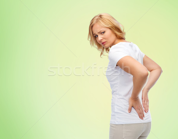 unhappy woman suffering from backache Stock photo © dolgachov