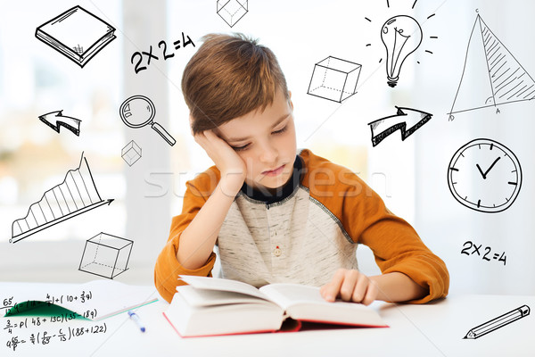student boy reading book or textbook at home Stock photo © dolgachov