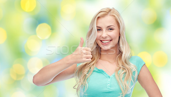 Stock photo: happy woman or teenage girl showing thumbs up