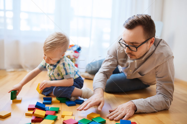 Stock photo: father and son playing with toy blocks at home