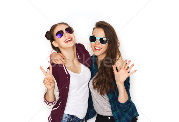 Stock photo: smiling teenage girls in sunglasses showing peace