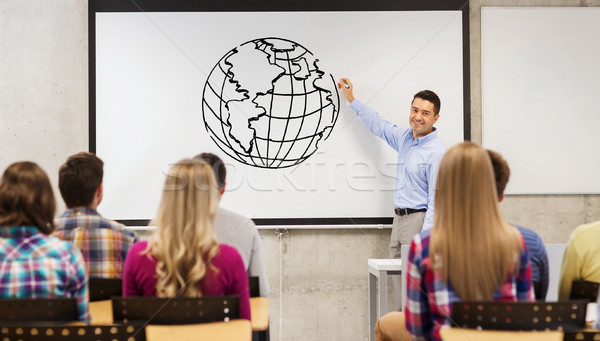 Stock photo: group of students and happy teacher at white board