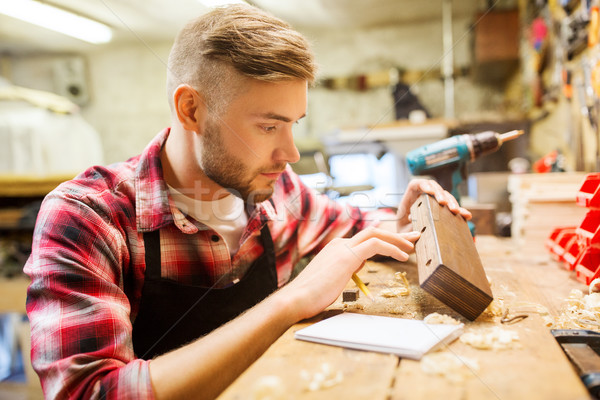 Stock photo: carpenter working with wood plank at workshop