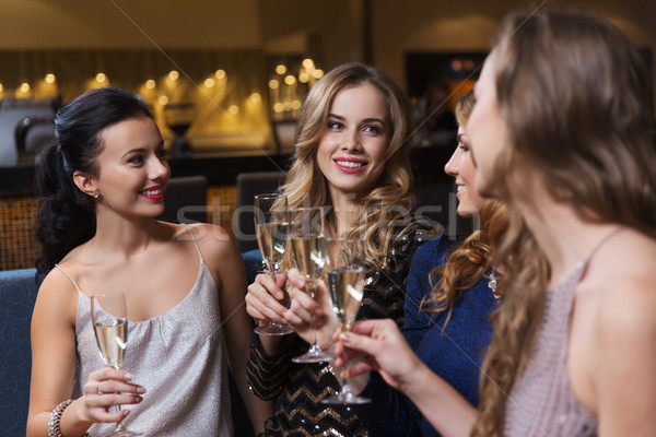 happy women with champagne glasses at night club Stock photo © dolgachov