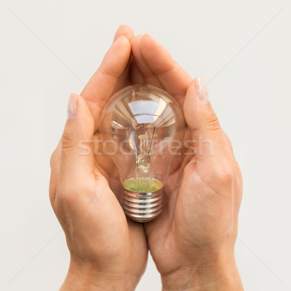 close up of hands holding edison lamp or lightbulb Stock photo © dolgachov