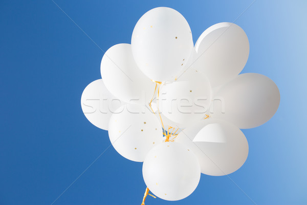 close up of white helium balloons in blue sky Stock photo © dolgachov