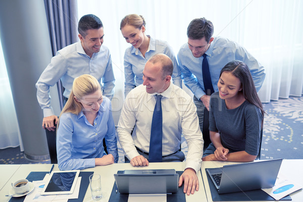 Mosolyog üzletemberek laptop iroda technológia csapatmunka Stock fotó © dolgachov