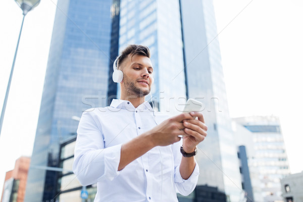 Stock photo: man with headphones and smartphone listening music