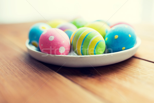 close up of colored easter eggs on plate Stock photo © dolgachov