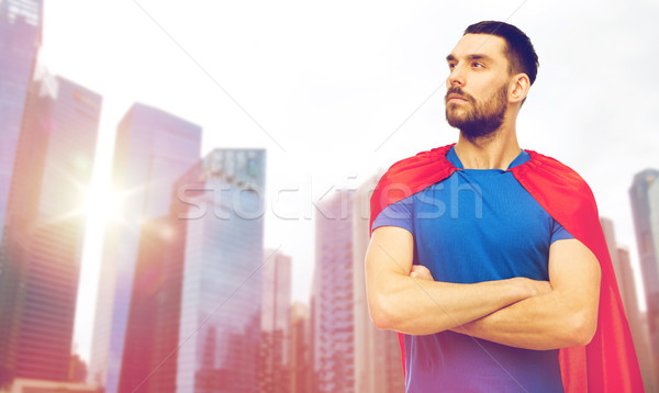 man in red superhero cape over city skyscrapers Stock photo © dolgachov