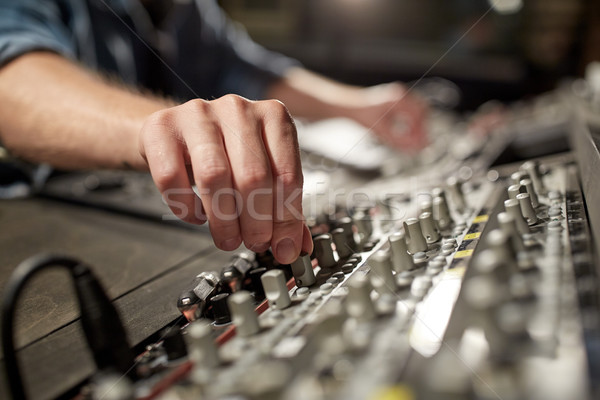 man using mixing console in music recording studio Stock photo © dolgachov