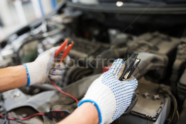 auto mechanic man with cleats charging battery Stock photo © dolgachov