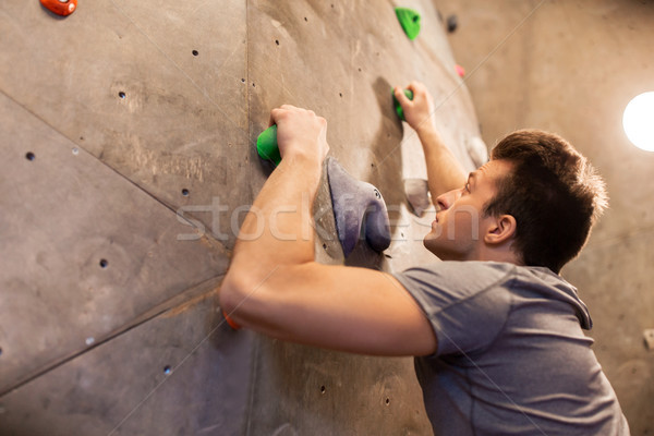 Stock photo: young man exercising at indoor climbing gym