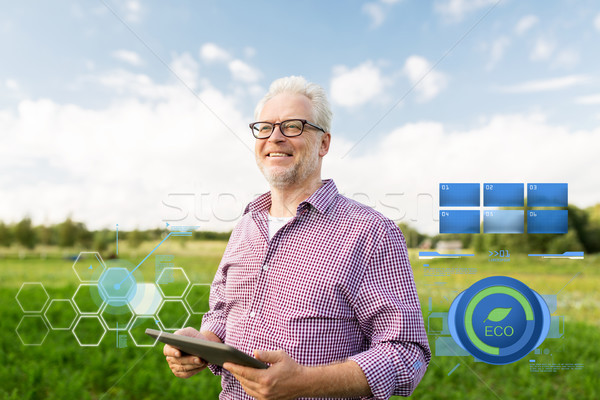 senior man with tablet pc computer at county Stock photo © dolgachov