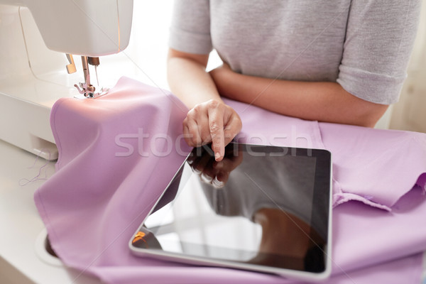 tailor with sewing machine, tablet pc and fabric Stock photo © dolgachov