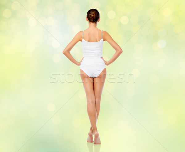 beautiful woman in white underwear over green Stock photo © dolgachov