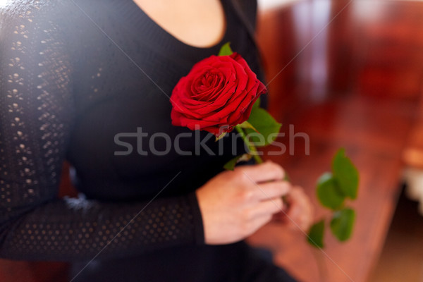 close up of woman with roses at funeral in church Stock photo © dolgachov