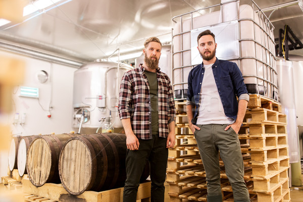 men at craft brewery or beer plant Stock photo © dolgachov