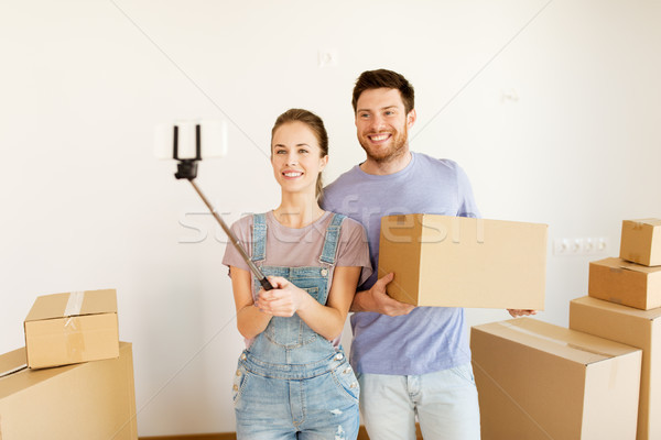 happy couple with boxes moving to new home Stock photo © dolgachov