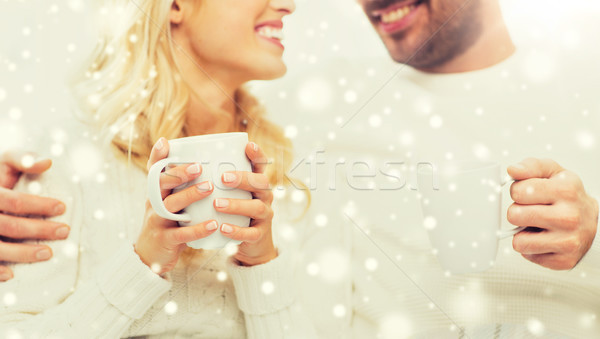 close up of happy couple with tea cups at home Stock photo © dolgachov