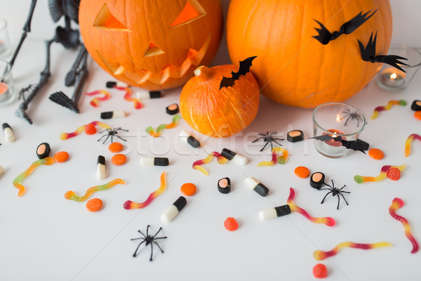 carved halloween pumpkins and candies Stock photo © dolgachov