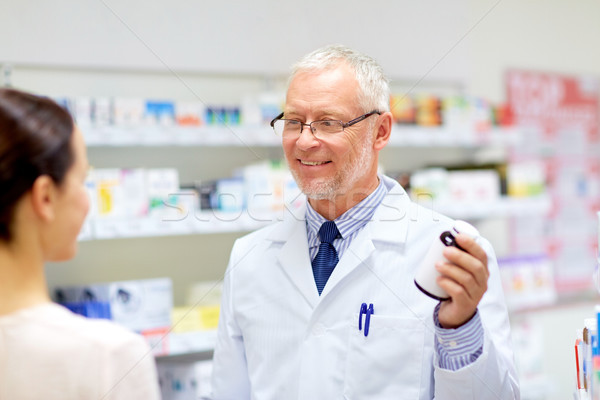 apothecary and woman with drug at pharmacy Stock photo © dolgachov