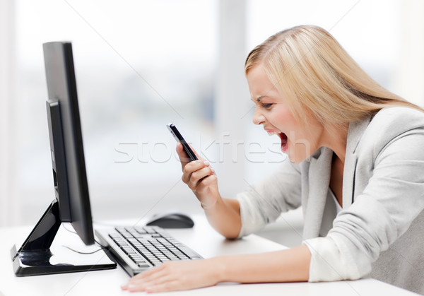 angry woman with phone Stock photo © dolgachov