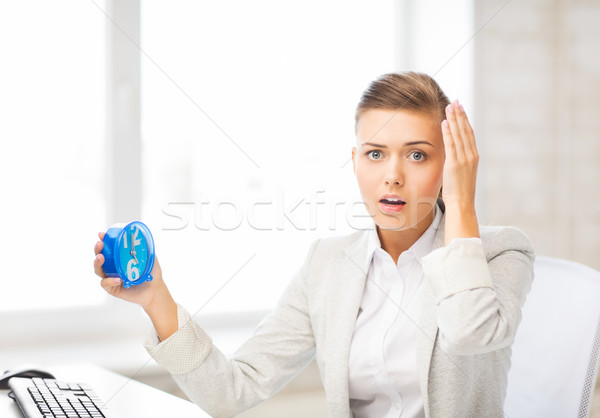 stressed businesswoman holding clock Stock photo © dolgachov