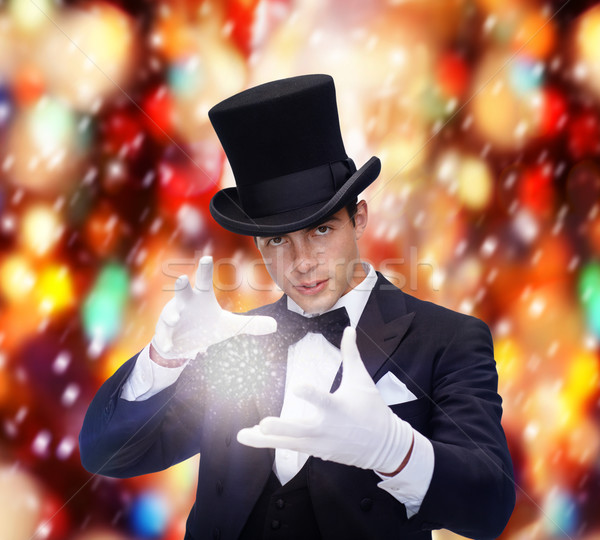 magician in top hat showing trick Stock photo © dolgachov