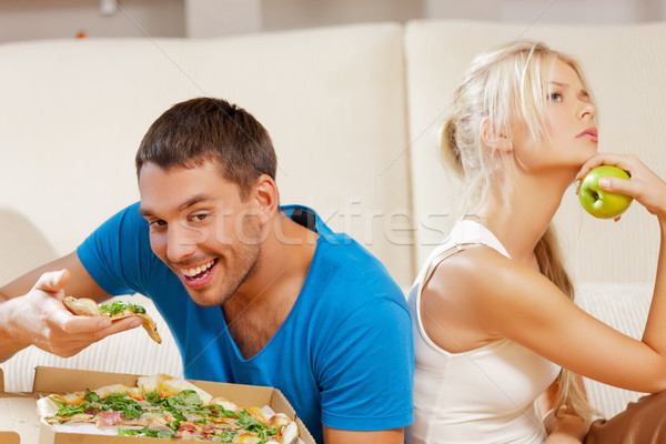 couple eating different food Stock photo © dolgachov