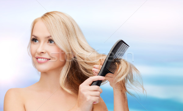 Stock photo: smiling woman with hair brush