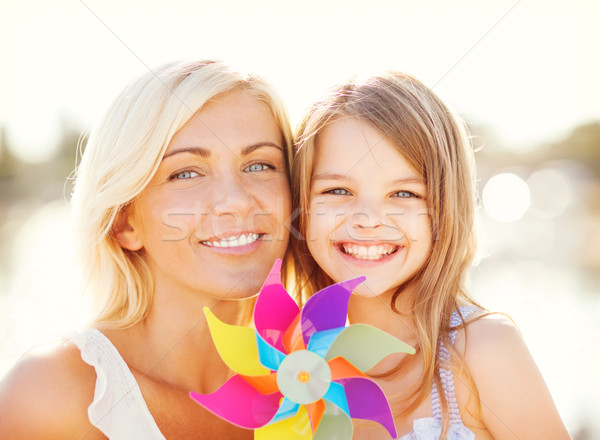 happy mother and child girl with pinwheel toy Stock photo © dolgachov