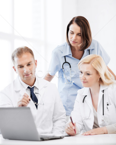 doctors looking at laptop on meeting Stock photo © dolgachov