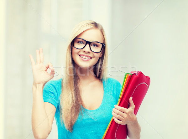 smiling student with folders Stock photo © dolgachov
