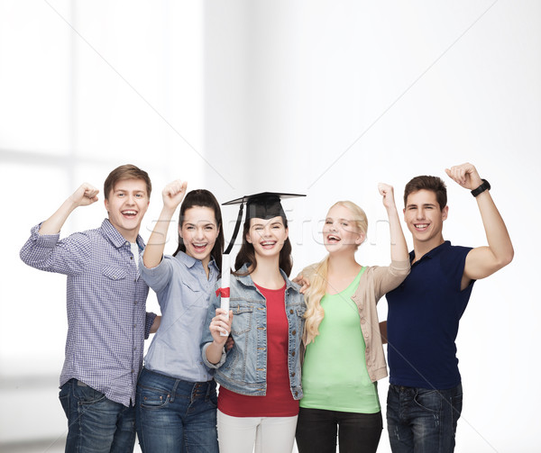 group of standing smiling students with diploma Stock photo © dolgachov