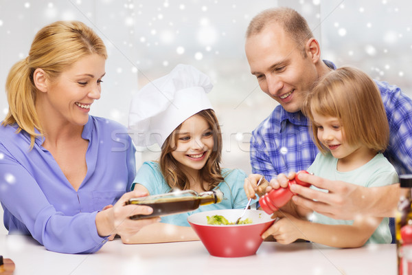 happy family with two kids making salad at home Stock photo © dolgachov