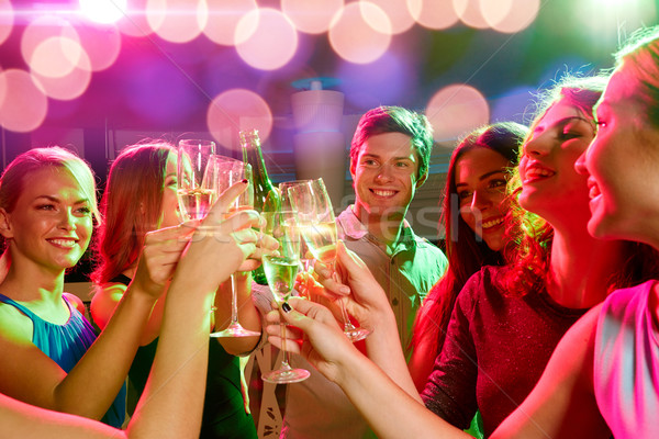 smiling friends with wine glasses and beer in club Stock photo © dolgachov