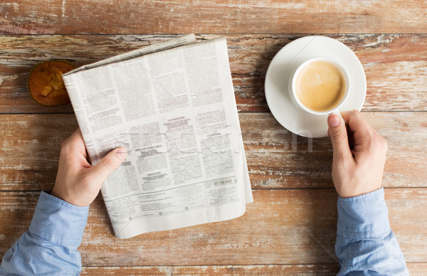 close up of male hands with newspaper and coffee Stock photo © dolgachov