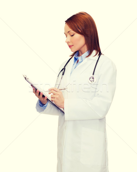 Stock photo: smiling female doctor with clipboard