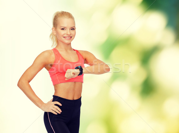 Donna sorridente frequenza cardiaca monitor mano fitness tecnologia Foto d'archivio © dolgachov