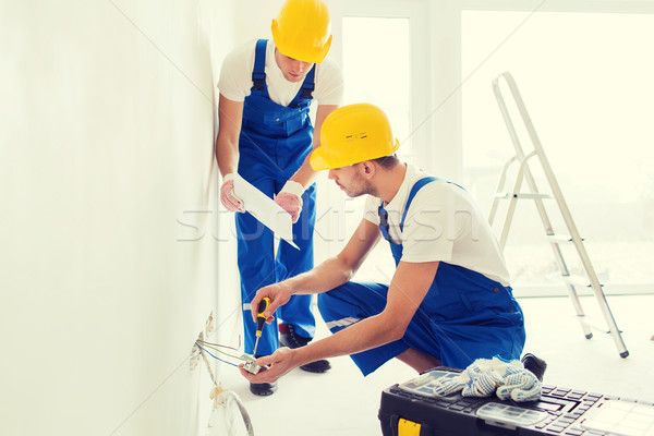 builders with tablet pc and equipment indoors Stock photo © dolgachov