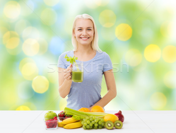 smiling woman drinking juice or shake at home Stock photo © dolgachov